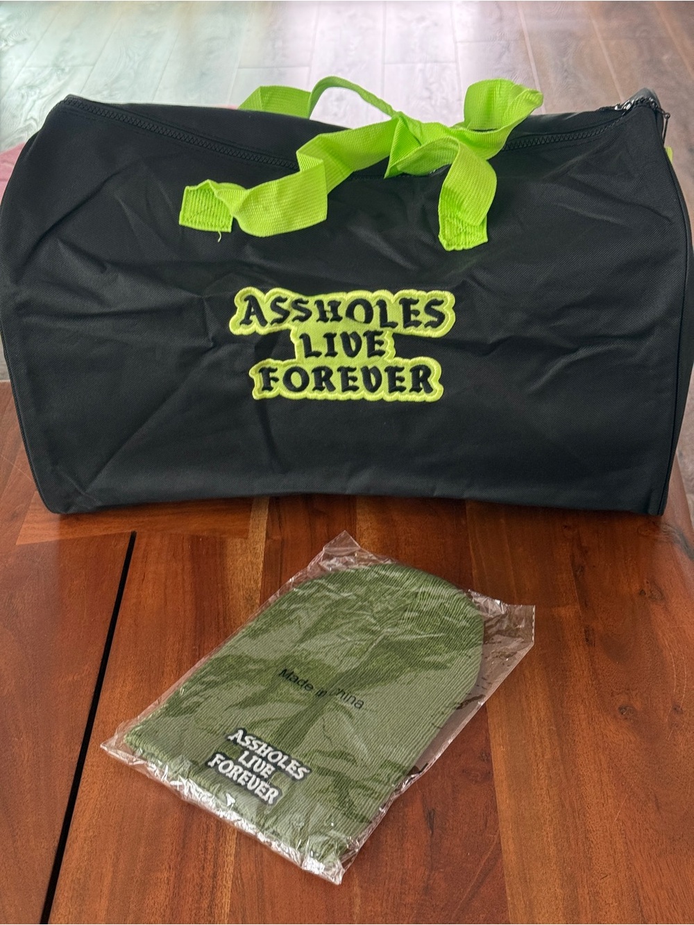 Assholes Live Forever Black & Neon Green Duffle Bag with FREE Beanie